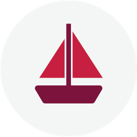 a sailboat with red sails and CIBC burgundy hull and mast