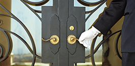 While glove on a gold door handle