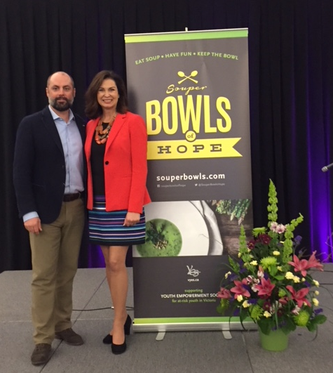Jake Brumby and woman standing next to Bowls of Hope banner